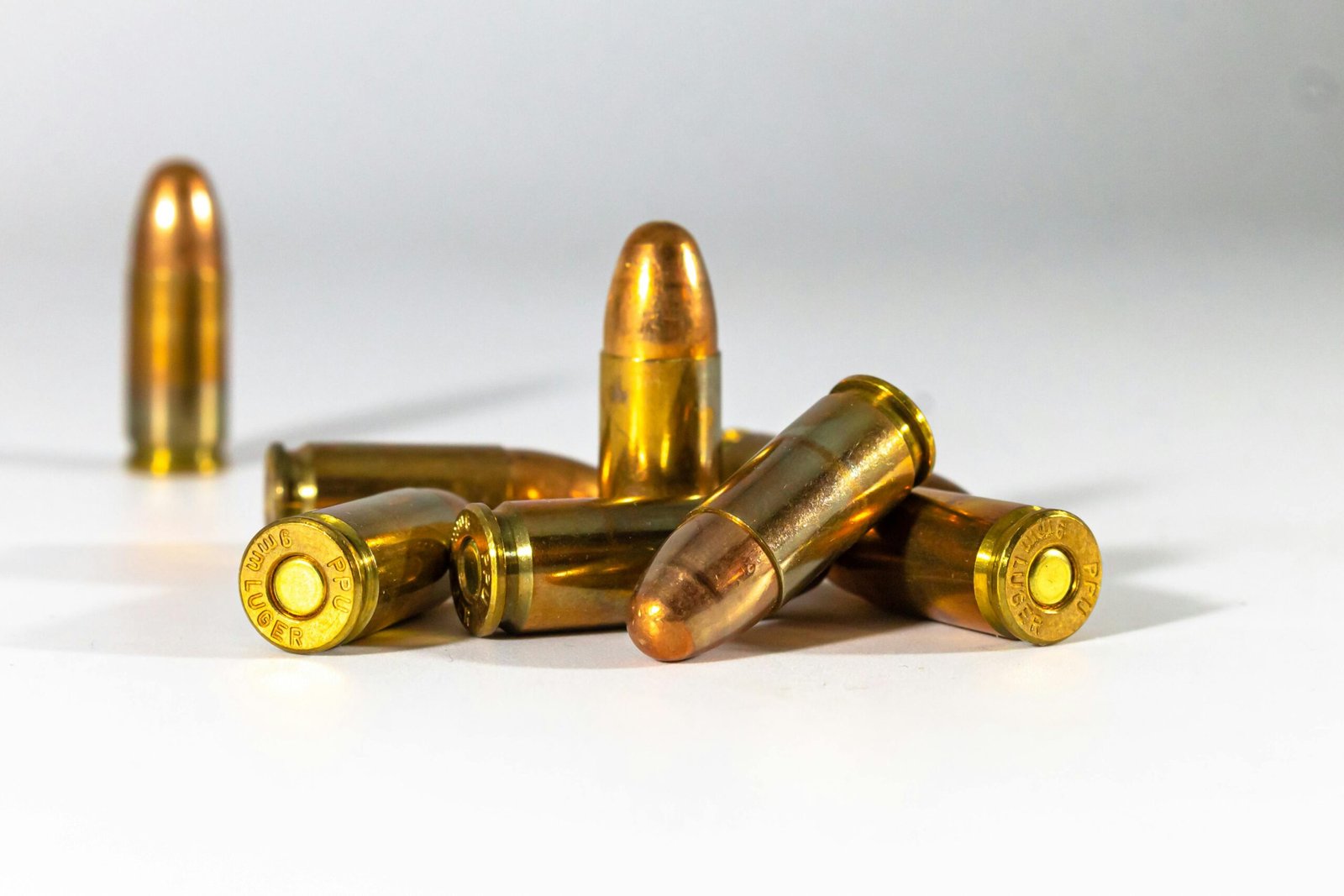A still life of bullets displayed on a white background, highlighting their metallic texture and shape.